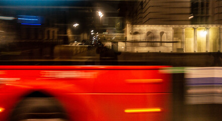 Blurred London bus at night