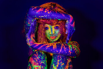 Let your light shine. Cropped portrait of a young woman posing with neon paint on her face.