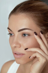 Beauty makeup. Woman face with beautiful eyes and eyebrows make-up and long black eyelashes closeup