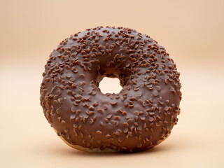 Chocolate donut on a brown background. Donut isolated on brown background.
