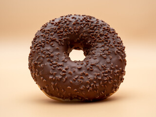 Chocolate donut on a brown background. Donut isolated on brown background.