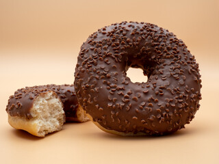 Chocolate donut on a brown background. Donut isolated on brown background.