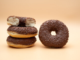 Chocolate donut on a brown background. Donut isolated on brown background.