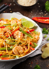 Stir fry noodles with prawns and vegetables in white plate. Healthy asian food