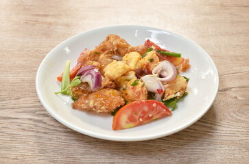 spicy batter slice fried egg with tomato and shallot Thai salad on plate
