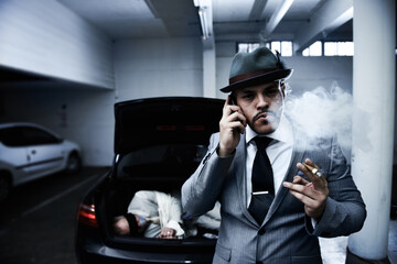 Letting his employers know the job is done. An arrogant mobster smoking a cigar and informing his...