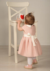 in focus mockup of a white cup with a heart pattern approached by a small child