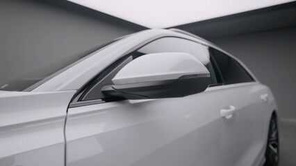 Modern car, view of car exterior, side doors and mirror, smooth camera movement. Action. Close up of a new passenger car at the salon.