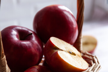 A part of composition with fruit. Close up. Apples. Fresh apples isolated in basket on wooden background. Harvest of apples. Spring. Food.