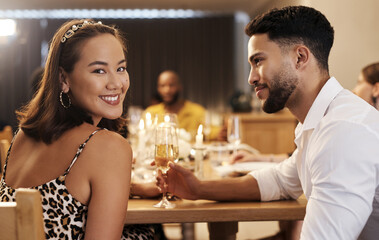 How did I get so lucky. Shot of an attractive young woman sitting with her boyfriend during a New Years dinner party.