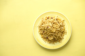 Bombay mix or Chiwda on yellow background 