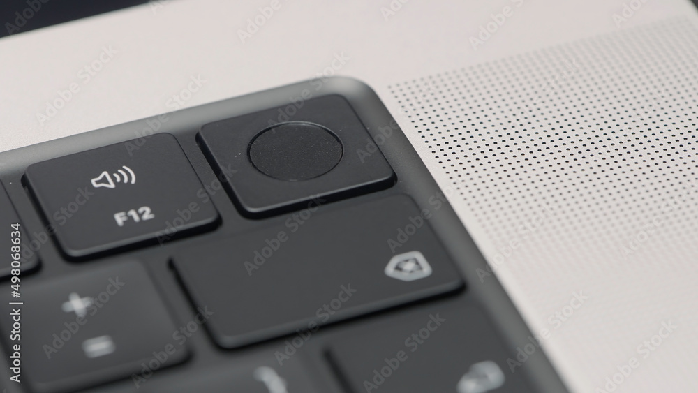 Poster extreme close up of black keyboard and silver laptop. action. buttons of a portable computer keypad.
