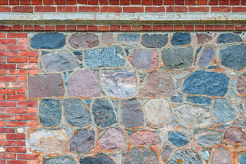 Antique masonry wall texture in a frame of red bricks