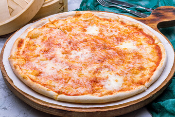 Italian pizza Margherita on the board on grey table