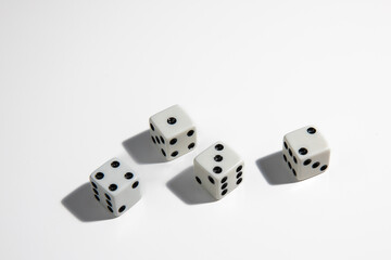 White dice with a one, two, three and four standing close to each other on a white background. Win or lose. Catch your luck. Gambling equipment.