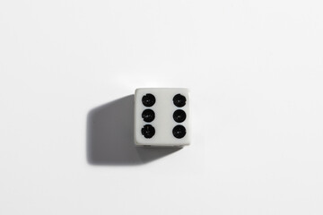 Single white dice with a six on a white background. Win or lose. Catch your luck. Gambling...