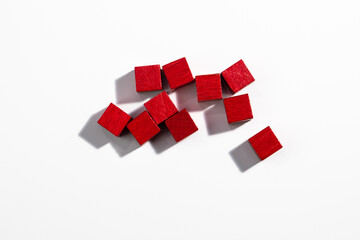 Top View of Red Wooden Game Cubes on White Background