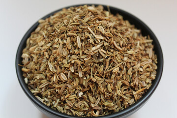 Dried granules of Aniseed, or Pimpinella Anisum seed, or Adas Manis, inside a bowl