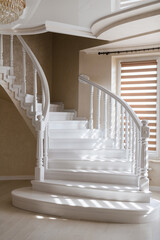 large elegant stairs and white railings made of natural wood