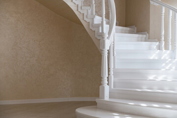 white stairs and handmade handrails made of natural wood in a new house