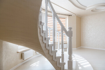 white stairs and handmade natural handrails in a new bright house