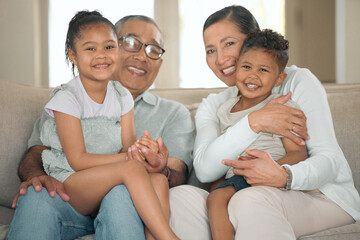 We love our weekends with our grandkids. Shot of a senior couple sitting on their sofa at home with...
