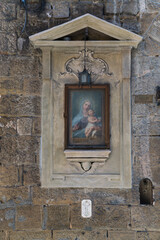 Street shrine with image of Virgin Mary and Child on a street in Florence, Italy 