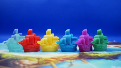 Colorful game pieces in the shape of pirate ships