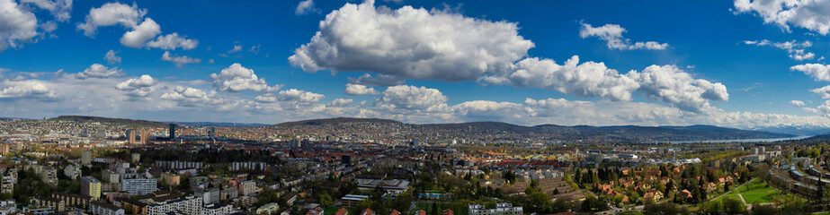 Fototapeta na wymiar Large panorama of the city of Zurich in sunny weather with white clouds
