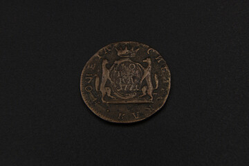 Old copper coin of Russian Empire on black background