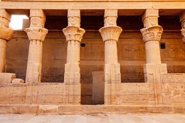 Fototapeta premium View of relief and hieroglyphs on the wall and the decoration on the columns at Temple of Isis .