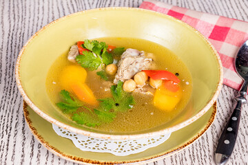 shurpa asian soup with lamb and vegetables on wooden table