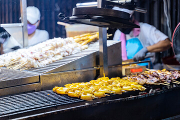 Fresh grilled squids in a street shop along the shore in Bangkok