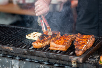 BBQ ribs. Chef brazier fries ribs on an open fire. Ribs fried over an barbecue