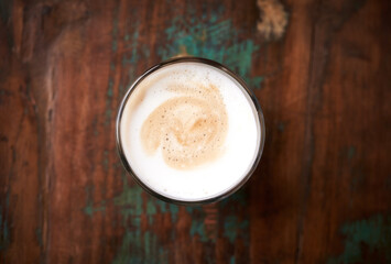 Coffee with milk on rustic wooden background. Soft focus. Top view.  Close up. Copy space.	