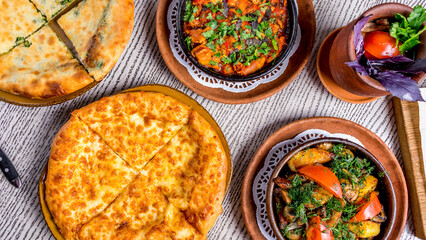 Georgian cuisine foodset from khachapuri, khachapuri with spinach, odjahuri with veal, chanakhi top view on wooden table