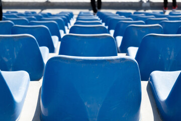 Rows of blue seats in a stadium .