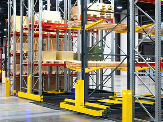 Modern warehouse. Storage rooms in industrial plant. Distribution company store. Concept warehouse logistics for distribution company. Steel racks with boards and boxes. Sale of warehouse equipment