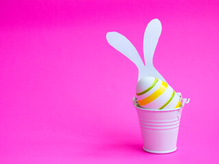 Easter minimalistic interior decor. with white bunny ears on a pink background. bright Easter holiday on April 24, free space