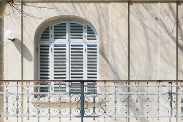 old window with closed white shutters