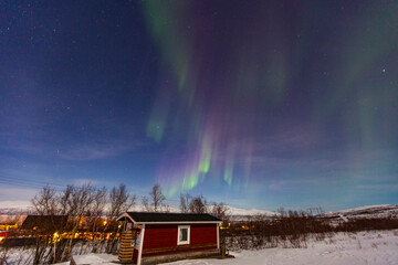 Fototapeta na wymiar Abisko, Aurora Borealis in Lapland. Sweden lights in the sky full of stars. Land of the Sami people. Solar wind colors
