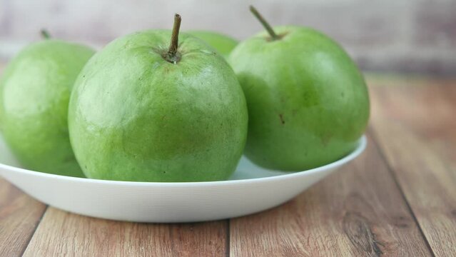close up of slice of guava on table 