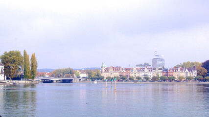 Fototapeta premium KONSTANZ, GERMANY - 14 OCT 2015: Lake Constance promenade with a bridge in the background