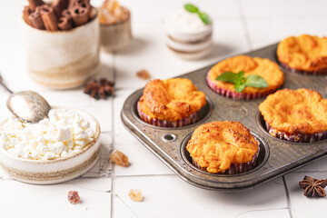 Sweet homemade cottage cheese muffins with pumpkin on white background