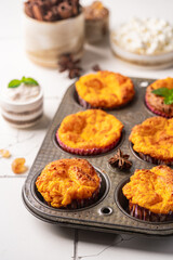 Sweet homemade cottage cheese muffins with pumpkin on white background