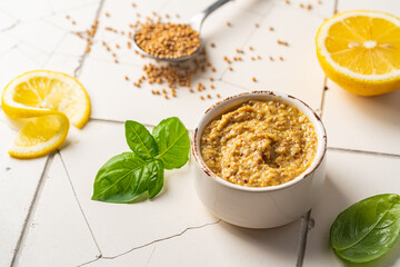 Fresh homemade organic dijon mustard in a bowl on white background, close up