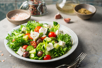 Classic vegetable salad with fresh olives, tomatoes, cucumbers, greek cheese feta and olive oil on...