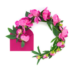 Round beautiful wreath of peonies with pink envelope and letter on white isolated background. Postcard for congratulations or invitations. Creative floral wreath.