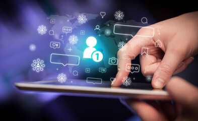 Close-up of a hand using tablet, social media concept