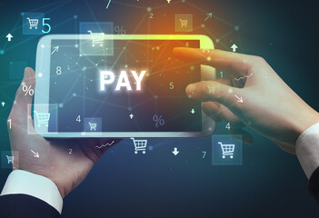 Close-up of a hand holding tablet with shopping inscription